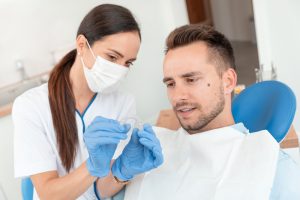 dentist showing patient invisalign aligner