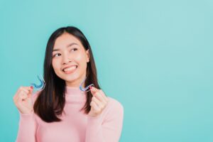 girl holding 2 silicone retainers