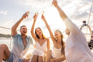group of friends on boat cheering with drinks