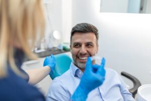dental assistant showing patient an aligner